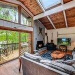 The living room at Lakeside on Lake Naomi has large windows that provide an amazing view of the water