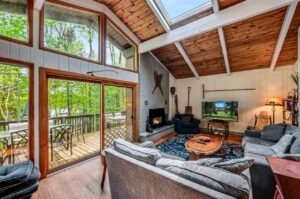 The living room at Lakeside on Lake Naomi has large windows that provide an amazing view of the water
