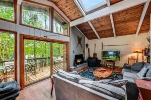 The living room at Lakeside on Lake Naomi has large windows that provide an amazing view of the water