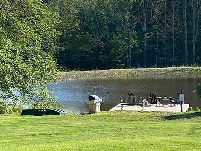 Dock, rowboat, gas grill at the pond